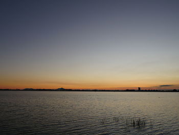 Scenic view of sea against clear sky during sunset