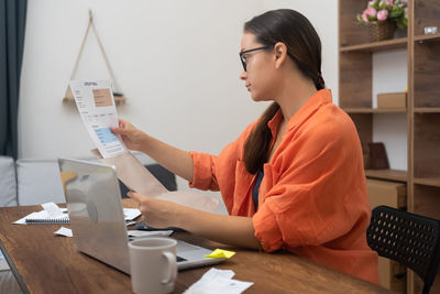 Side view of man working at office