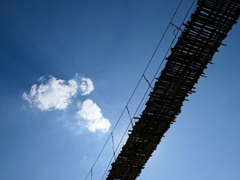 Low angle view of crane against blue sky