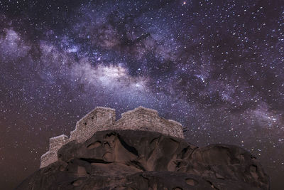 Statue against sky at night