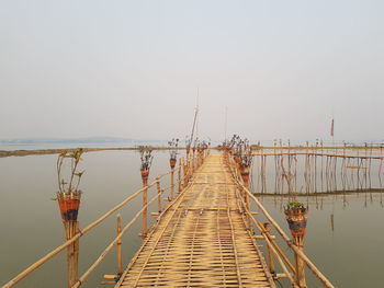 Pier over sea against clear sky