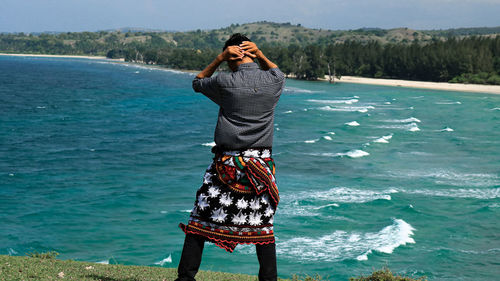 Woman standing at sea shore