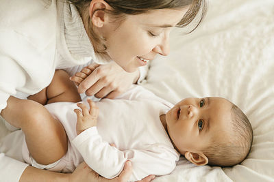 Mother playing with daughter at home