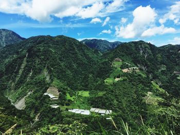 Scenic view of mountains against cloudy sky