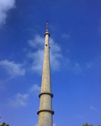 Low angle view of tower against blue sky