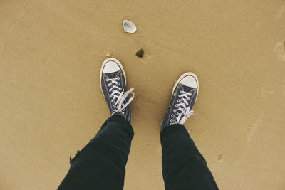 Low section of man standing on tiled floor