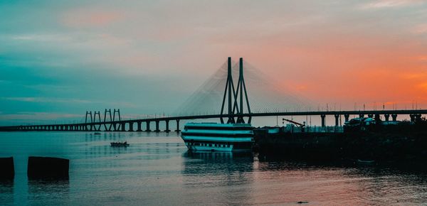 Bridge over sea against sky during sunset - bandra worli sea face 