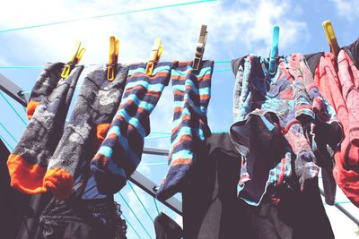 Low angle view of clothes hanging against sky