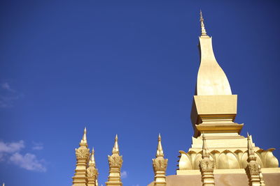 Low angle view of a temple building against blue sky