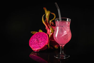 Close-up of drink on table against black background