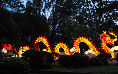Illuminated sculpture against sky at night