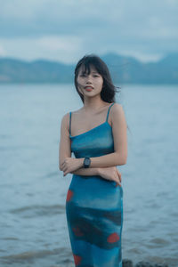 Young woman standing at beach