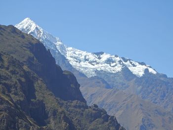 Scenic view of snow covered mountains against clear sky