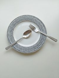 High angle view of fork in plate on table