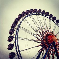 Low angle view of ferris wheel against sky