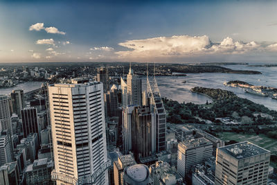 High angle view of buildings by sea against sky