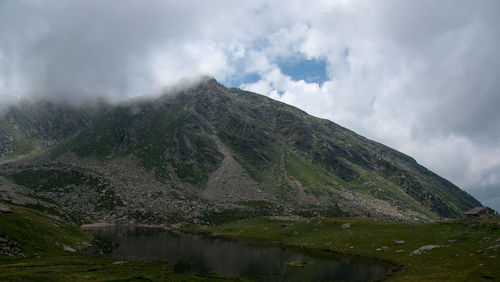 Scenic view of lake and mountains against sky