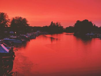 Scenic view of lake against orange sky