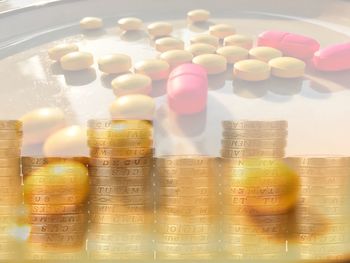 Close up of stacked coins and medicines