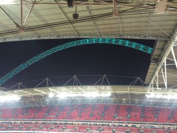 Low angle view of illuminated bridge at night