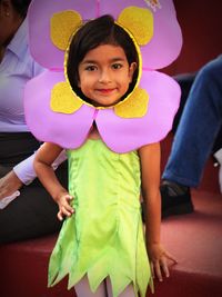Portrait of happy girl in flower costume standing outdoors