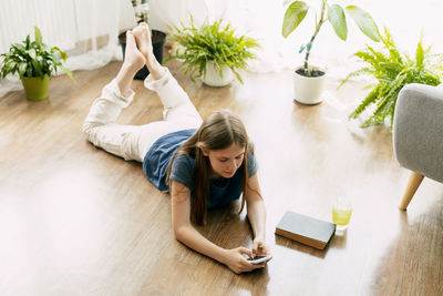 High angle view of mother and daughter sitting on table