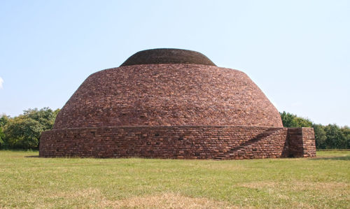 Built structure on field against clear sky