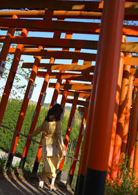 Rear view of woman standing at playground