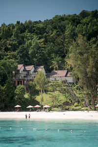 Houses on beach against clear sky