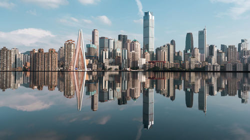 Reflection of buildings in lake against sky