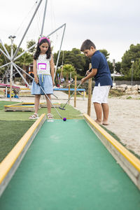 Children playing mini golf