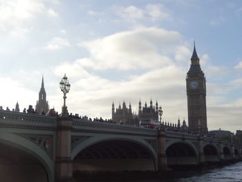 Bridge over thames river against sky