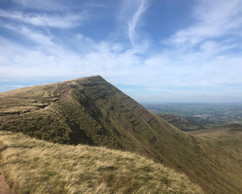 Scenic view of mountain against cloudy sky