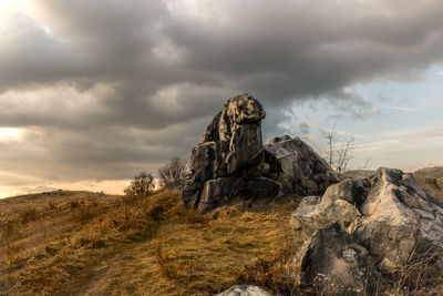 Rock formations on landscape against sky