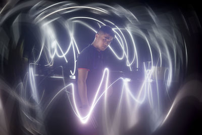 Digital composite image of light painting against black background