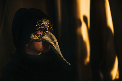 Close-up of boy wearing mask on stage