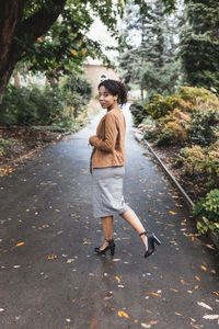 Young woman walking on road