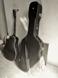 Close-up of guitar on wall at home