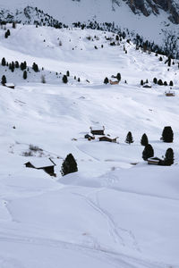 People skiing on snow covered landscape. winter hike around seceda, south tyrol, italy