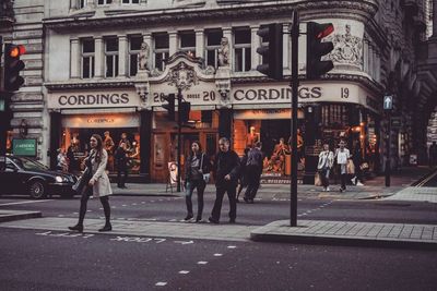 People walking on road in city