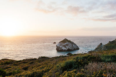 High angle view of rock in sea against sky