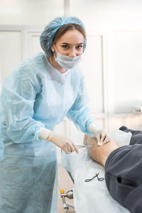 Portrait of young woman working at clinic