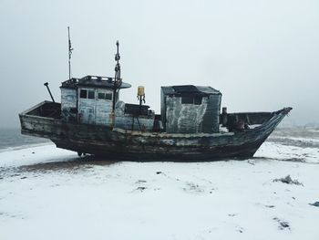 Side view of abandoned boat on the beach