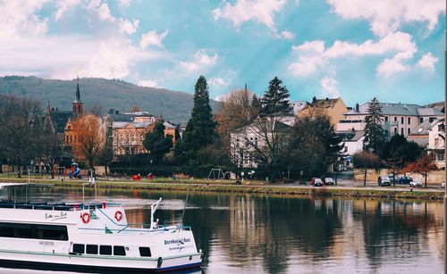 Panoramic view of city by lake against sky