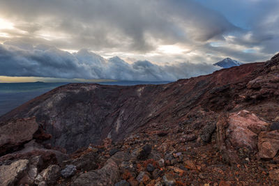 Scenic view of sea and mountains against sky