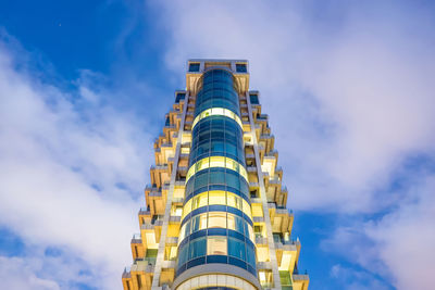 Low angle view of building against cloudy sky