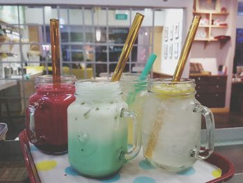 Close-up of drinks in mason jars on table