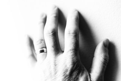 Close-up of hands against white background