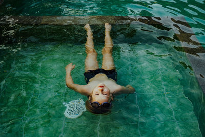 High angle view of boy swimming in pool