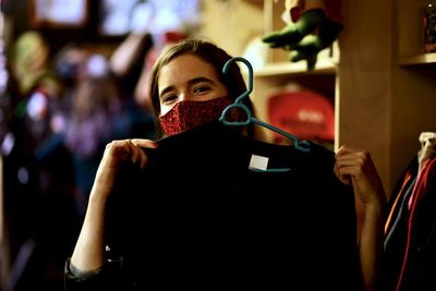 Smiling young woman holdind black tshirt